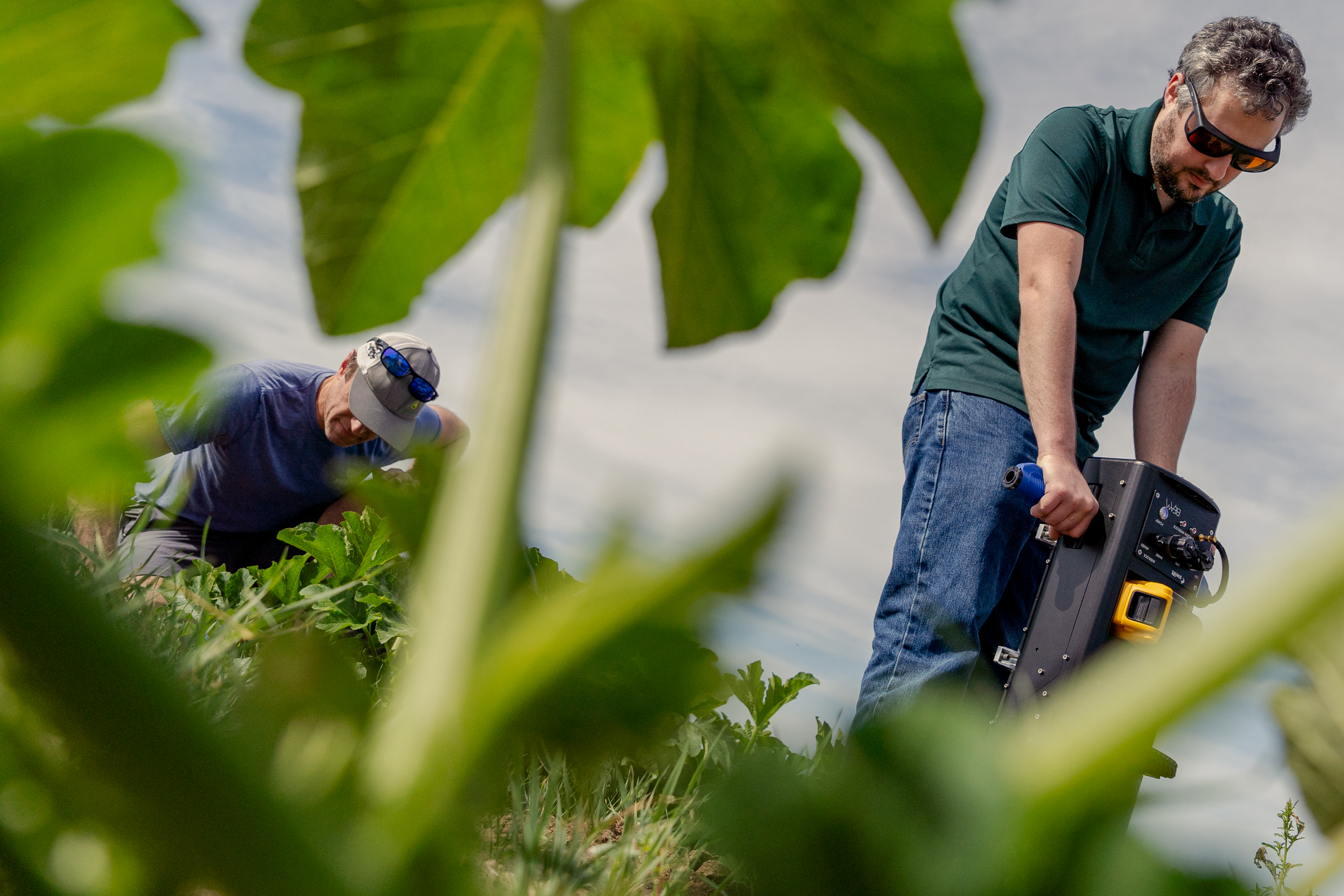 A man taking soil samples on a farm.